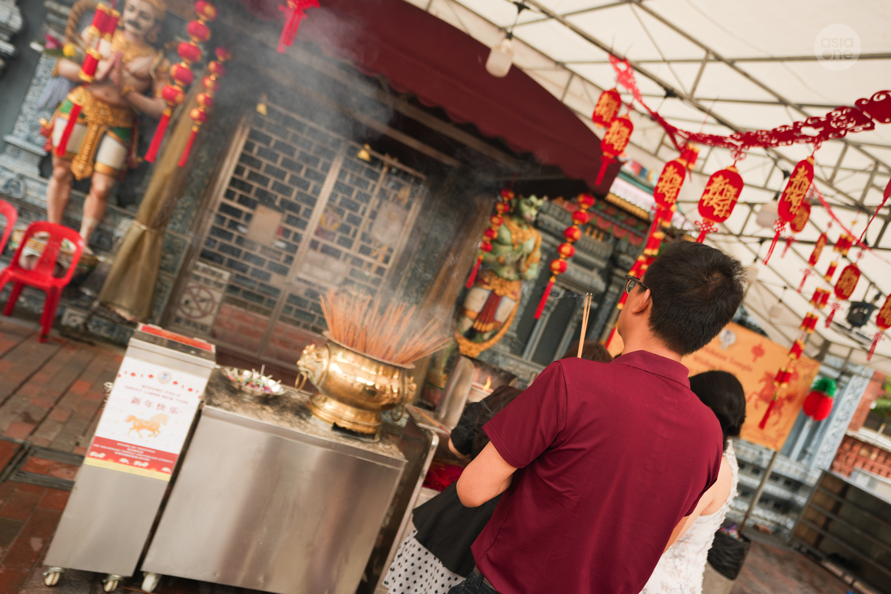 A devotee praying at Sri Krishnan temple, also in Waterloo Street, on the eve of Chinese New Year (Feb 16).