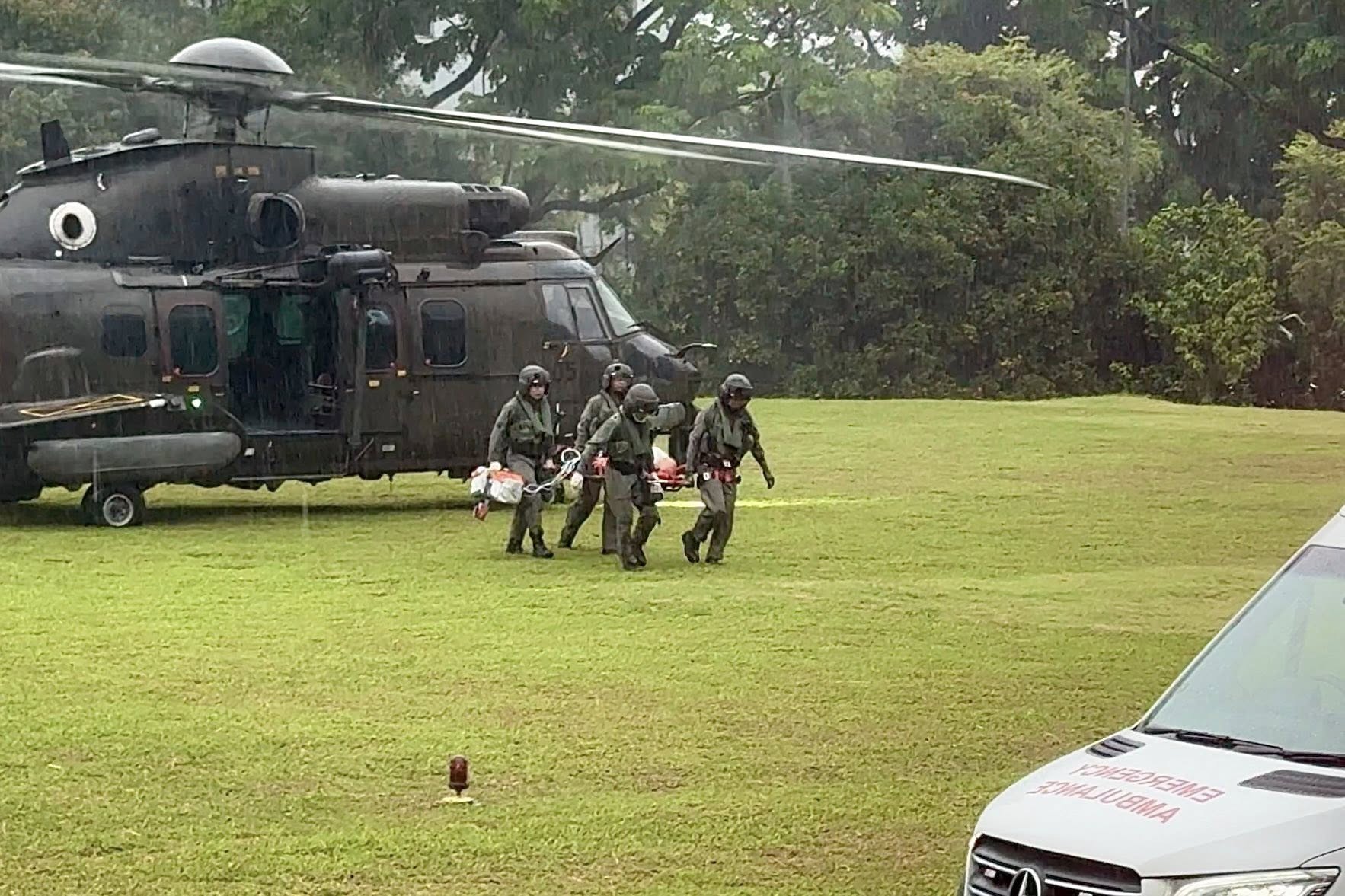 Rescue 10's crew transferring the patient to a waiting SGH ambulance on Feb 14.
