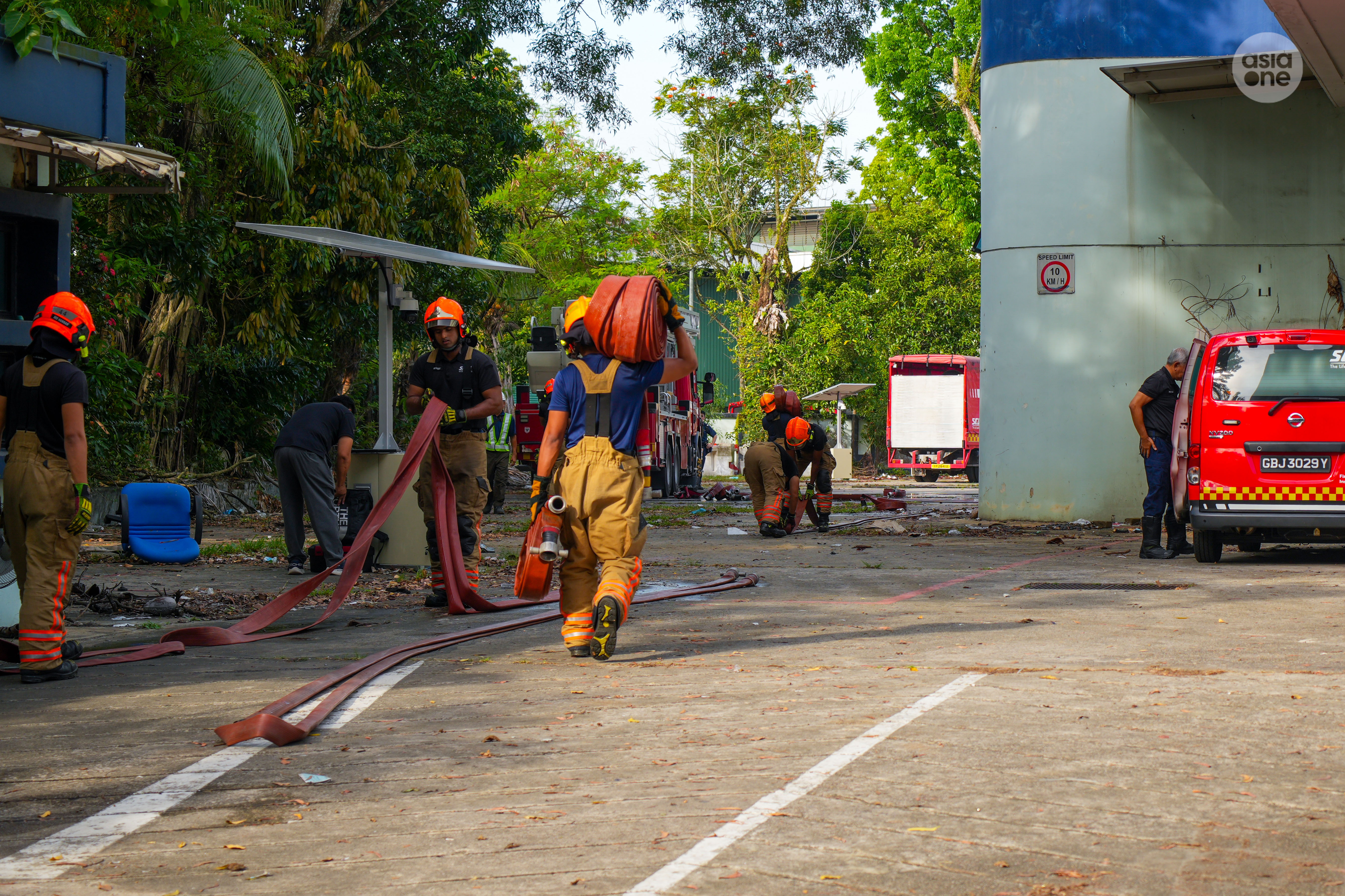 SCDF firefighters packing their gears after the fire was extinguished.