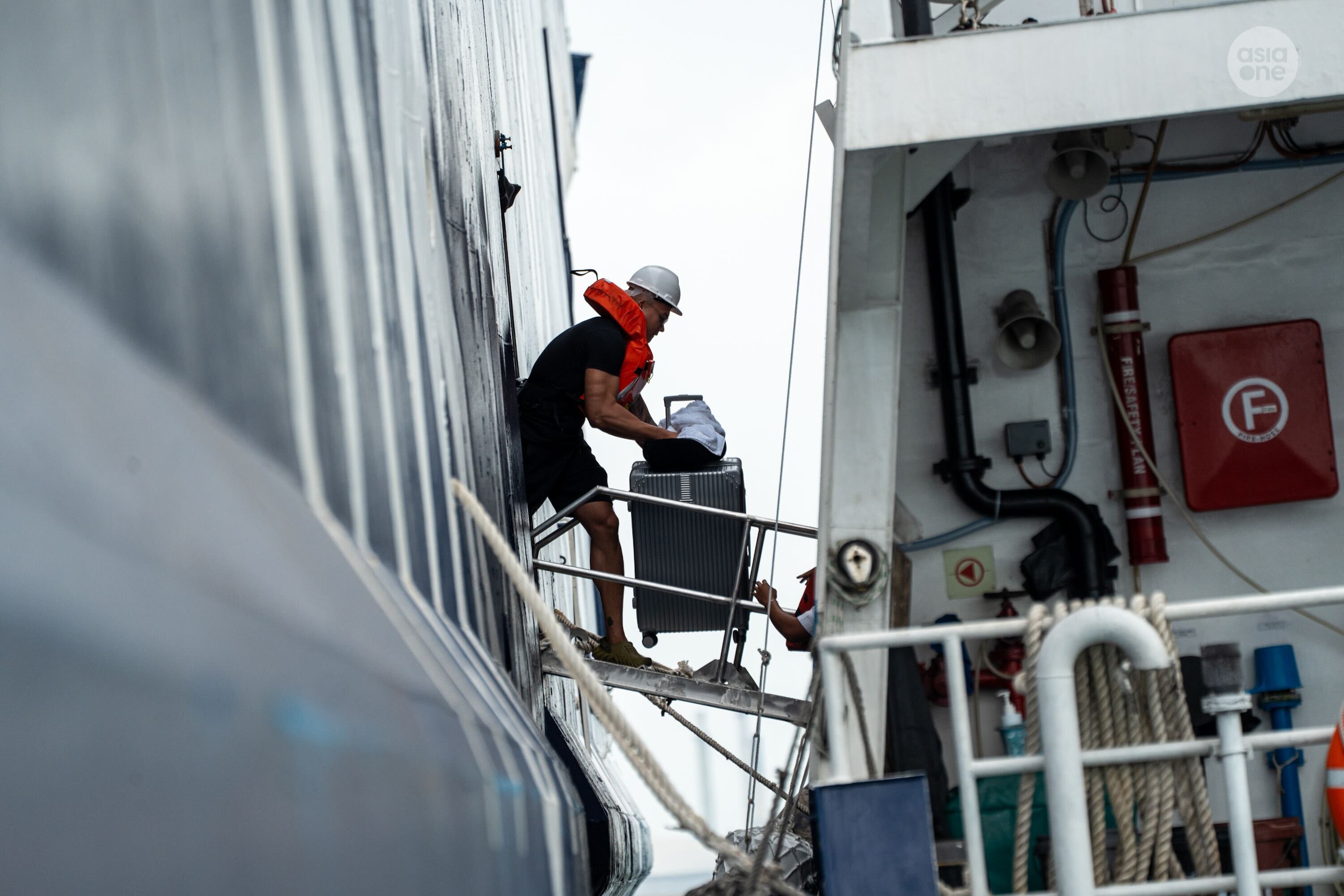 A World Legacy crew member disembarking the cruise ship at around 4.30pm on Friday (Feb 20).
